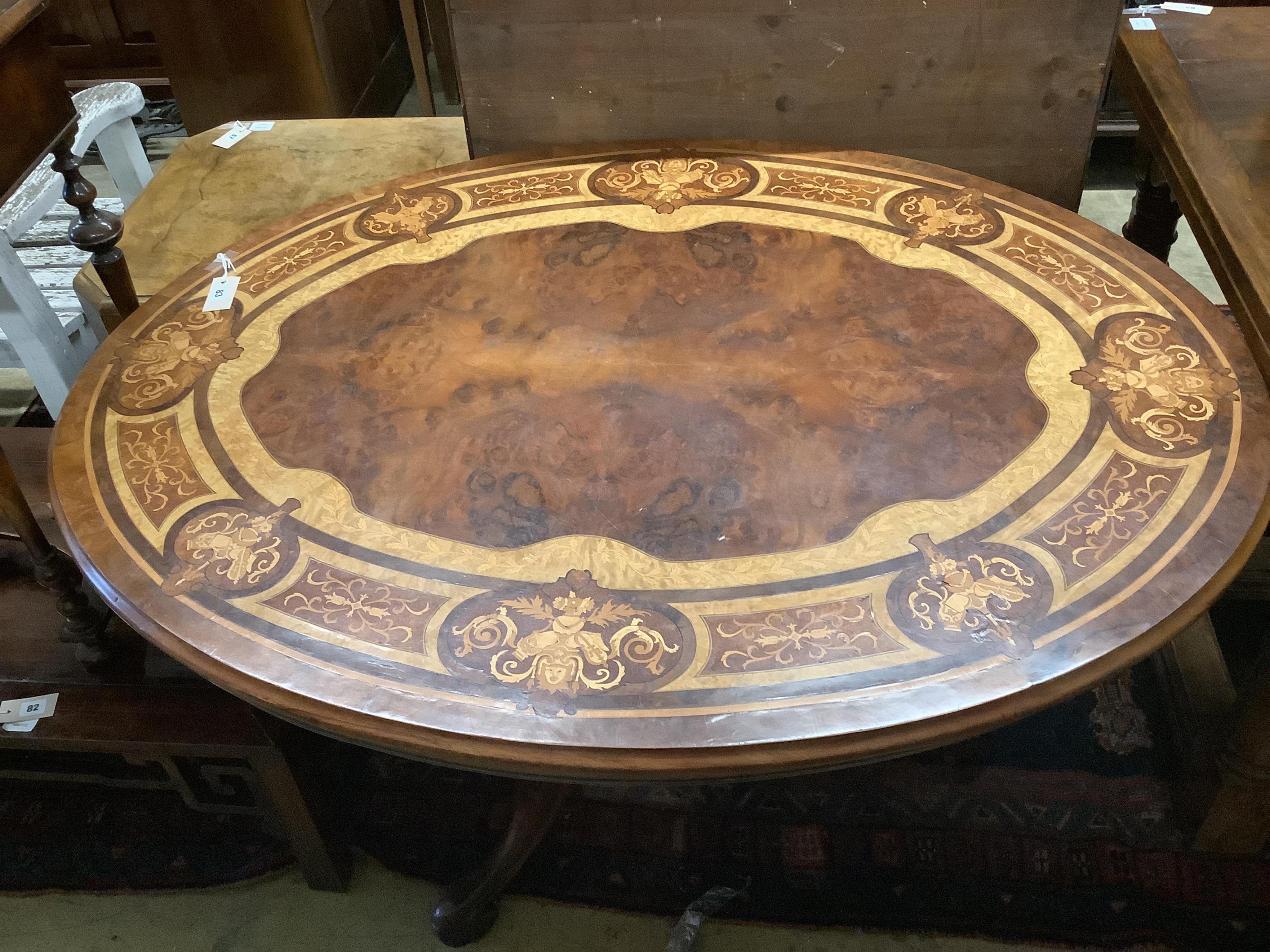 A Victorian and later marquetry inlaid oval walnut tilt top loo table, width 132cm, depth 100cm, height 71cm. Condition - fair